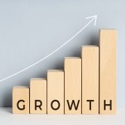 Growth concept. Wooden block bar chart graph with text and upward trend line drawn on background. Copy space