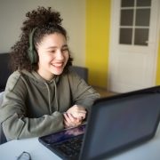 happy mixed rase girl sits at computer screen lapt 2025 01 16 07 46 02 utc