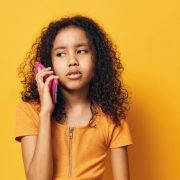preteen holding phone