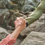 pulling hand of hiker while helping to move up 2025 03 18 22 14 10 utc